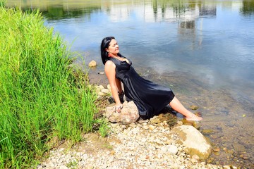 A woman in black on riverside of Neris river in Vilnius