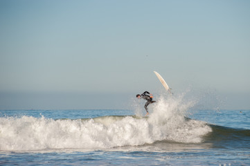 Surfer and board flying in opposite directions.