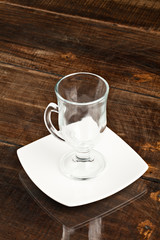 Empty cup placed against a sleek and polished table top,creating a visually striking contrast that adds elegance to any space.