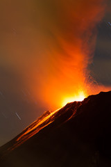 A breathtaking landscape of a volcanic eruption, with fiery lava flowing down the mountain and...
