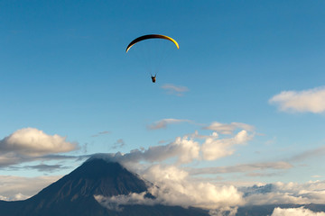 An Ecuadorian paraglider soars through the sky, embracing the extreme sport of paragliding in the beautiful landscapes of Ecuador.