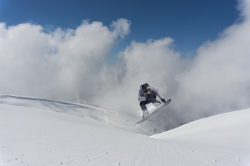 Flying snowboarder on mountains