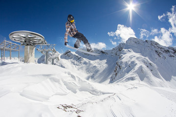 Flying snowboarder on mountains
