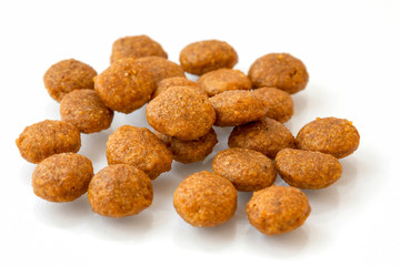 A pile of dry dog treats and cat food isolated on a white background, perfect for treating your furry pets.