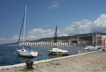 Boats moored in harbor in Trieste, Italy on summer day