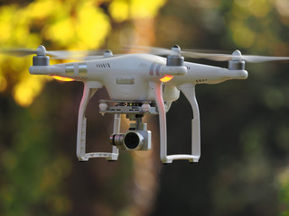 Fliegende Drohne vor Bäumen