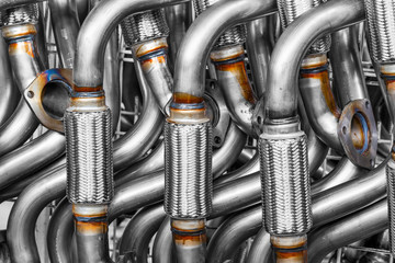 A galvanized automotive exhaust pipe being welded, filtering CO2 gases through tubes in the...