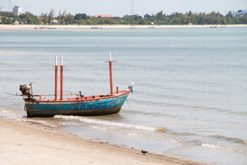 Fototapeta premium Fishing boat on the sea with sand in Thailand