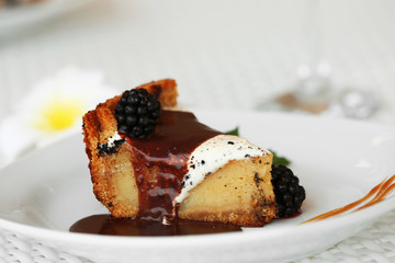 Delicious cake under chocolate glaze with blackberry