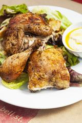 crispy free-range rotisserie chicken on organic butterleaf salad