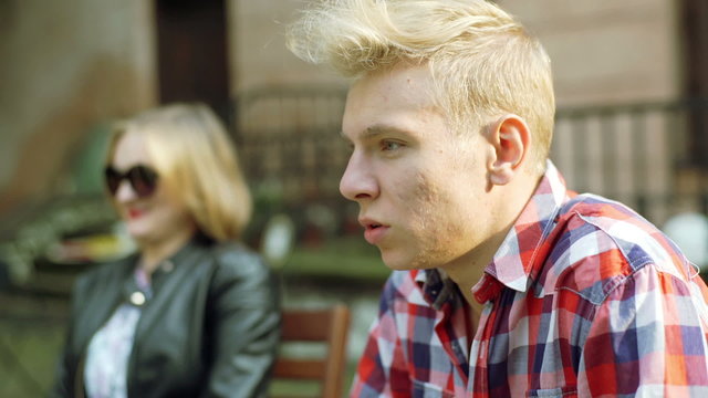 Boy looking morose and talking with his girlfriend
