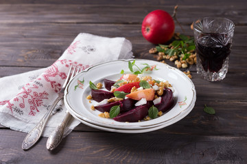 Fototapeta na wymiar Beet salad with apples, walnuts and feta cheese, style vintage, selective focus