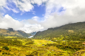 A breathtaking view of the Andes mountains in Ecuador, overlooking the lush greenery of Puyo and the vast expanse of the Amazon.