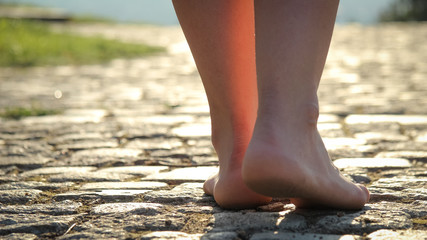 Young girl walking on the sun