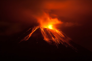 A breathtaking scene of an active volcano in Ecuador erupting at night, spewing lava and magma into the dark sky over rocky mountains. - obrazy, fototapety, plakaty