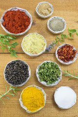 Different spices in shiny bowls