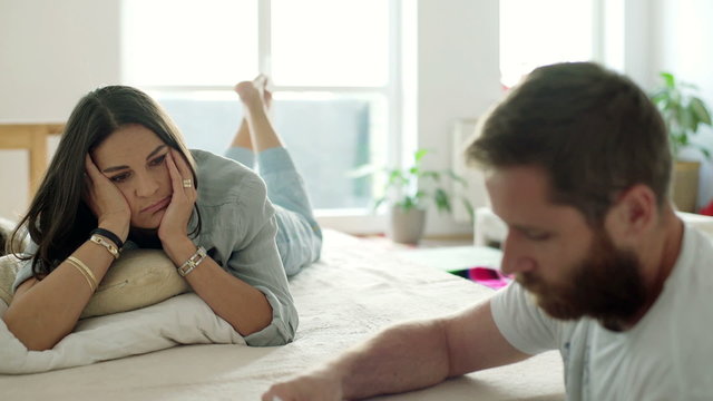 Couple sitting in the room in the morning and having an argument
