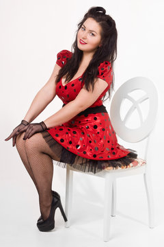 Attractive pin-up girl sitting on a chair