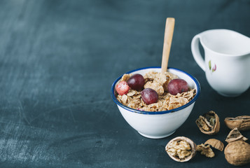 breakfast with cornflakes and milk on dark wooden table