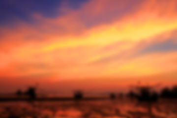 Blurred image of colorful sunset on the beach background.