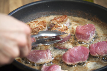Chef preparing fillet mignon.