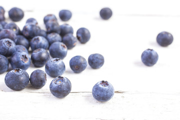 blueberries shot front on on white wooden boards