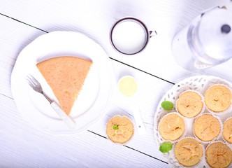 Cornbread muffins and milk on white table