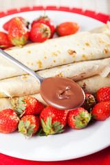 Pancakes with chocolate and strawberries