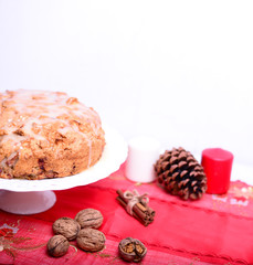 Fresh Christmas cake with apples and walnuts on table