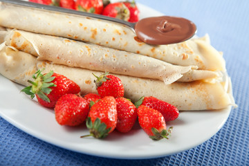 Pancakes with chocolate and strawberries