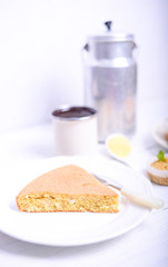 Peace of cornbread on white table
