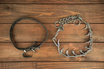 Collar leather and strict on the wooden background
