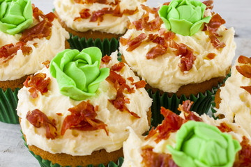 Cupcakes cabbage and bacon shot close-up front on at an angle on white wooden boards landscape