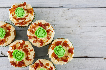 cup cakes cabbage and bacon shot from above on white wooden boards landscape