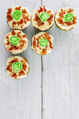 cup cakes cabbage and bacon shot from above on white wooden boards portrait