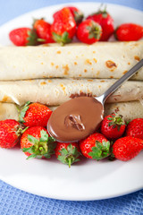 Pancakes with chocolate and strawberries