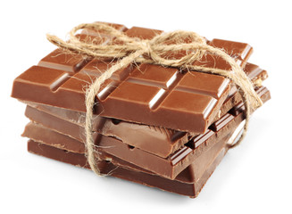 Milk chocolate bar with bow on color wooden background