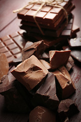 Variety of chocolate pieces on wooden background