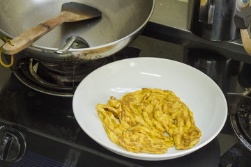 The fried egg Cooking in a pan at a kitchen
 Smell good and easy to do - thailand food