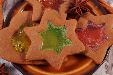 Stained glass gingerbread on old wooden background, christmas time