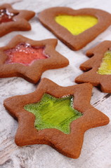 Stained glass gingerbread on old wooden background, christmas time