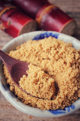 Brown sugar with sugar cane