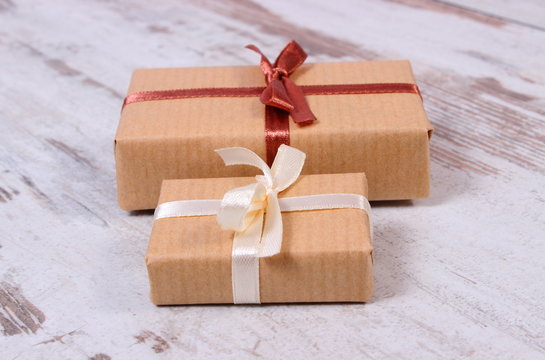 Wrapped gifts for Christmas or other celebration on old wooden background