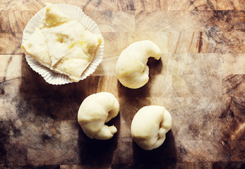 Fresh pastry dough on rustic wooden background