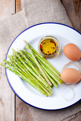 Fresh asparagus, olive oil and eggs .