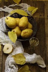 White wine, pears in a wattled basket and an autumn branch