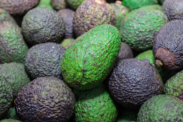 Avocado background. Fresh green avocado on a market
