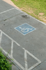 Obraz premium parking space reserved handicapped on road with disabled sign