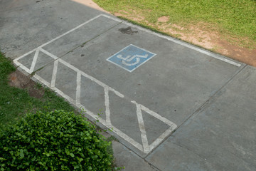 parking space reserved handicapped on road with disabled sign