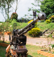 Young boy dressed like a soldier with a gun in barracks
